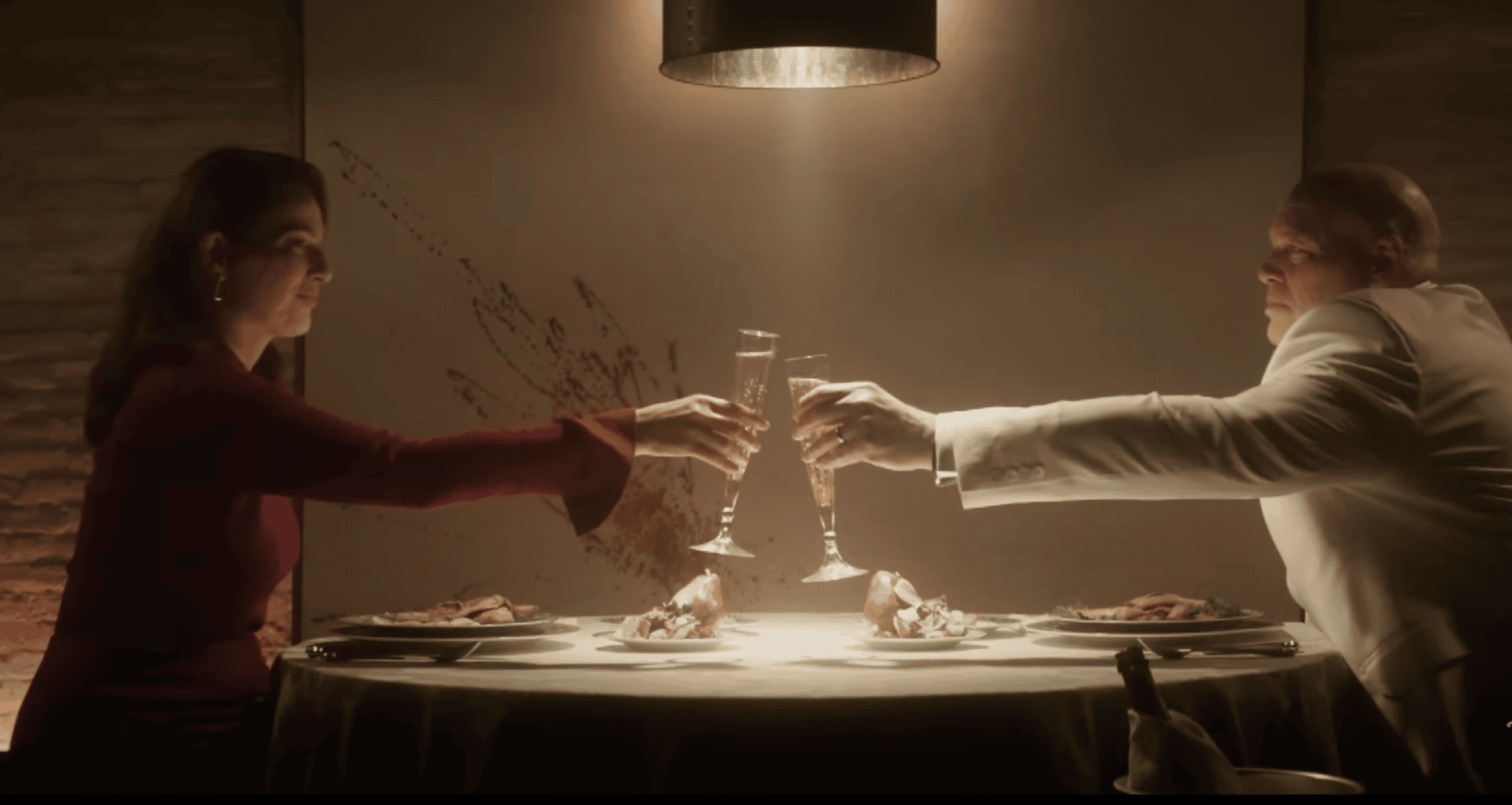 Kingpin and Vanessa toast over a long dinner table.