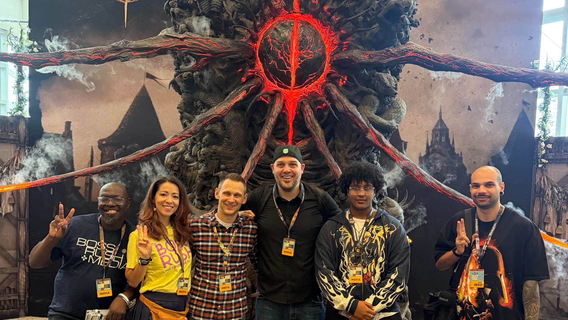 A group of Boss Rush Network reporters stand in front of a statue